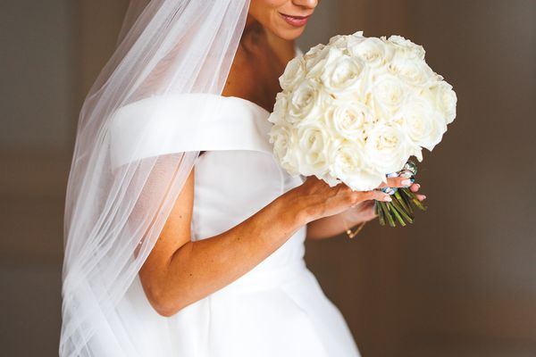 bride holding a white rose bouquet at wedding venue near Hereford